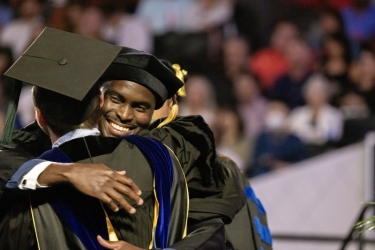 photo of graduates embracing