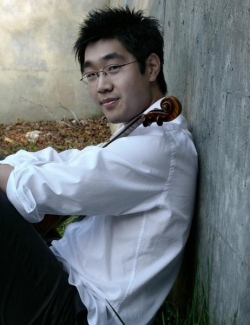 Soovin Kim leans against wall with instrument