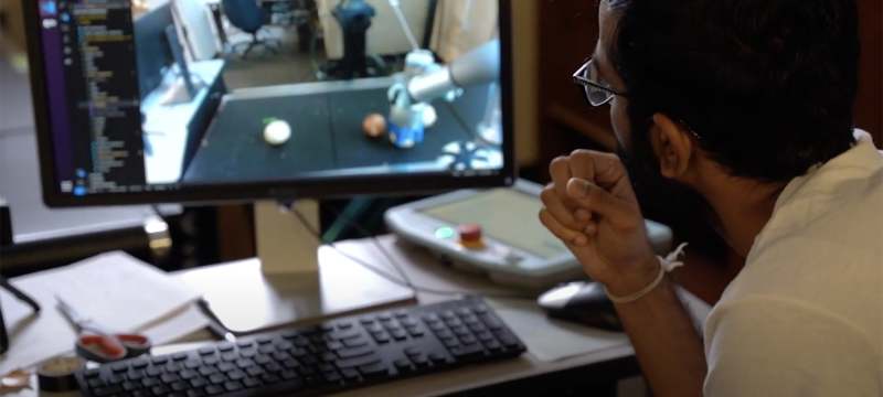 video still image of man looking at computer screen