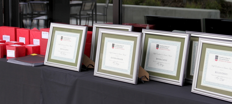 photo of table with framed certificates