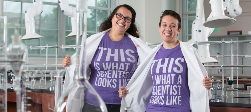 photo of women in lab coats and t-shirt in a lab