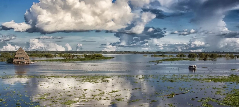 photo of flooded river, with clouds, day
