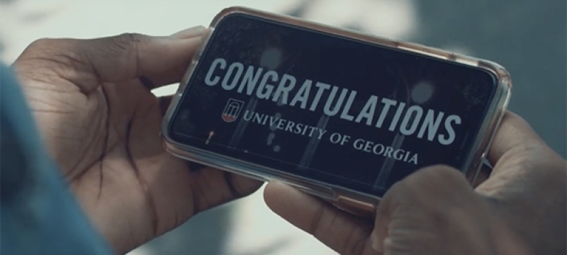 photo of hands holding a cell phone with congratulations