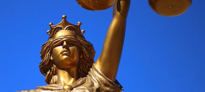 photo of statue of Lady Justice (Goddess), with blue sky