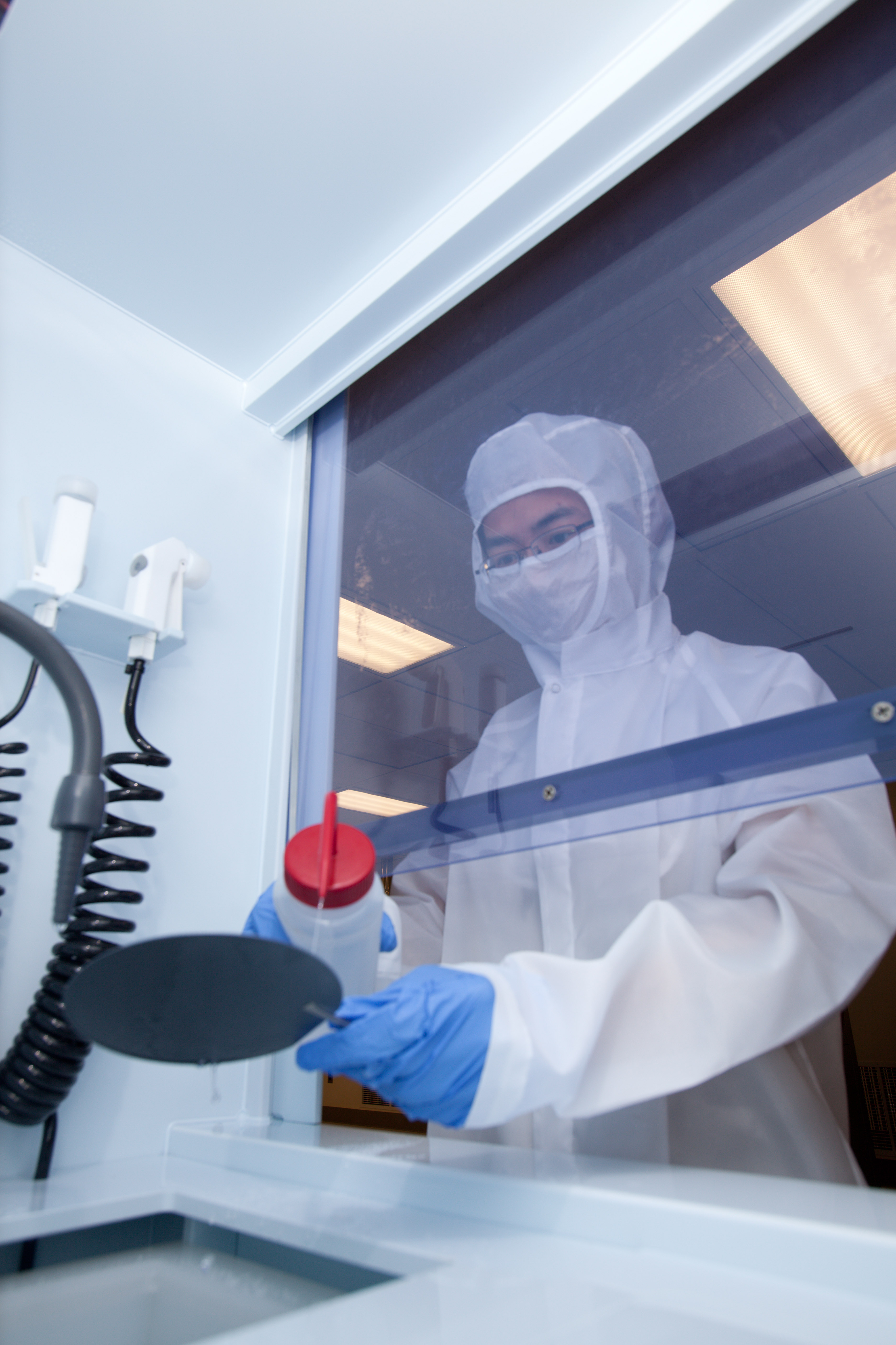 Researcher reaching through window 