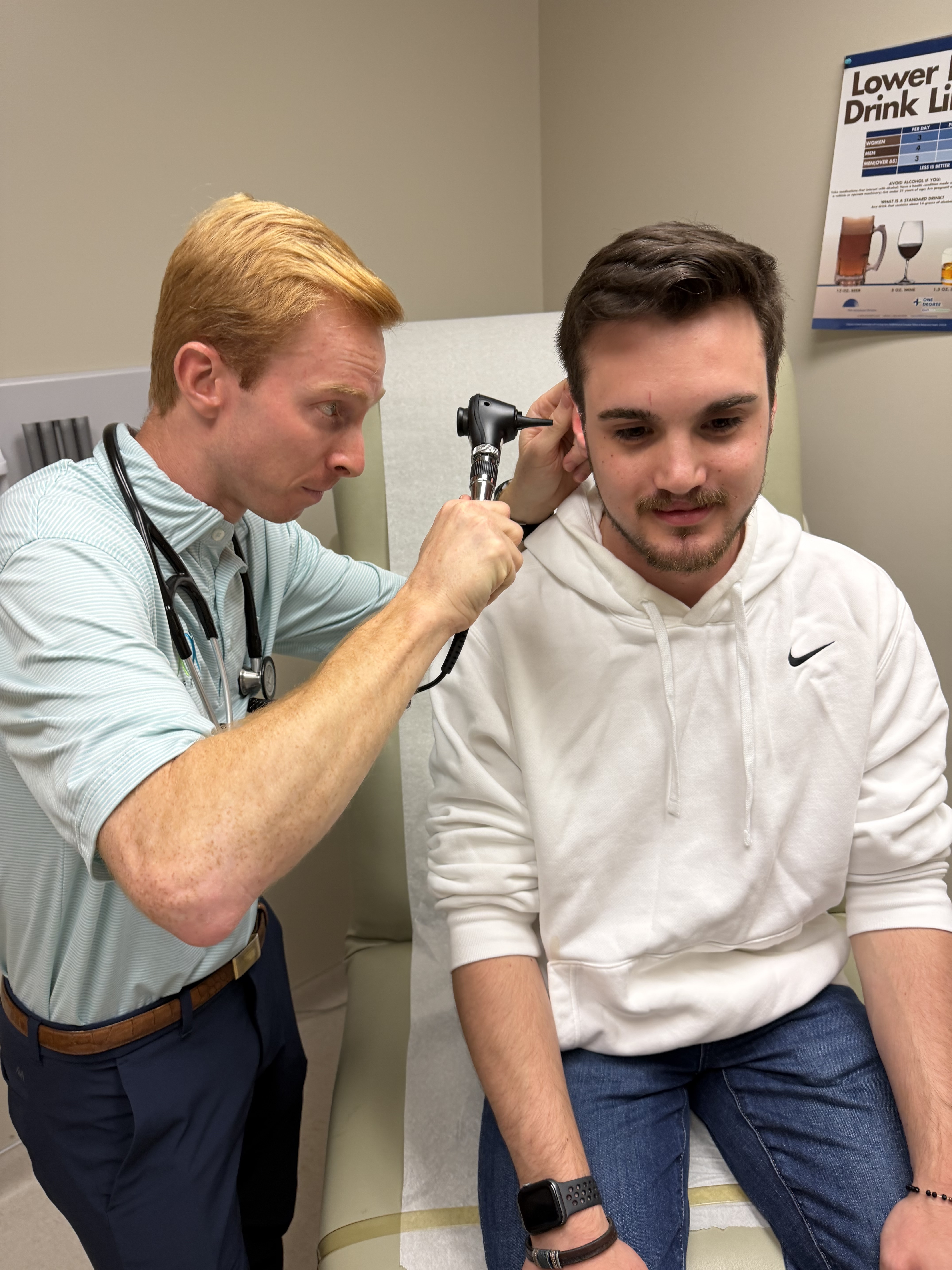 Cole Phillips checking patient's ear