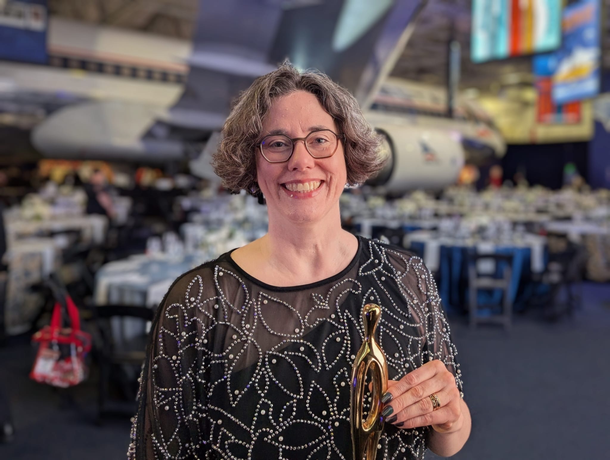 photo of woman with award trophy