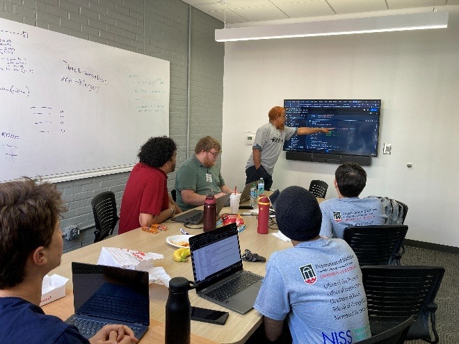 Students at Data Fest looking at presenter pointing at screen