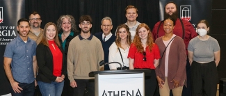 group photo of people behind podium
