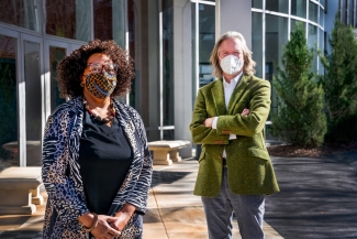 photo of two people wearing masks, outside