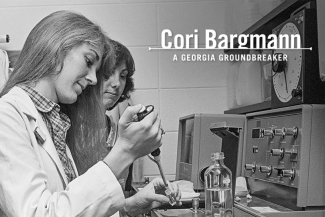 black and white photo of two people in a lab, woman in foreground 
