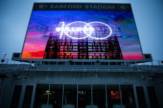 photo of stadium sign illuminated at twilight