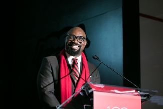 photo of man speaking at podium