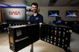 photo of man, with equipment, screens and signs
