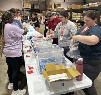 photo of people packing supplies in warehouse