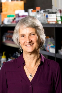 photo of woman with lab shelving in background