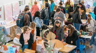 photo of people browsing tables at art market