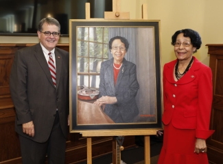 photo of two people with a painted portrait