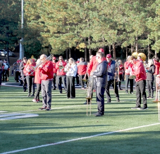 photo of people on field with band instruments
