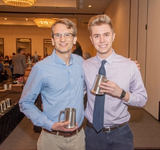 Photo of two men holding silver steins