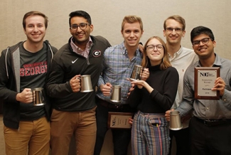 photo of six students holding award cups