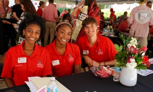Photo of three people in red shirts