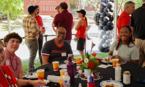 photo of multiple people seated, standing