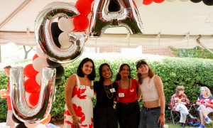 photo of four people with balloon letters