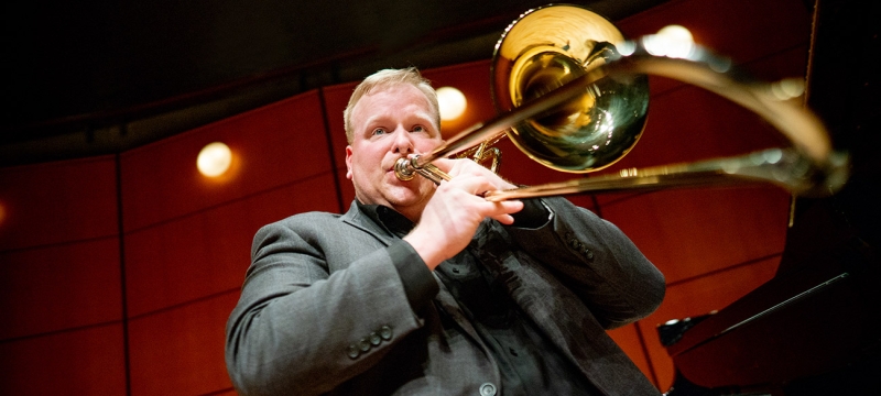 photo of man playing trombone