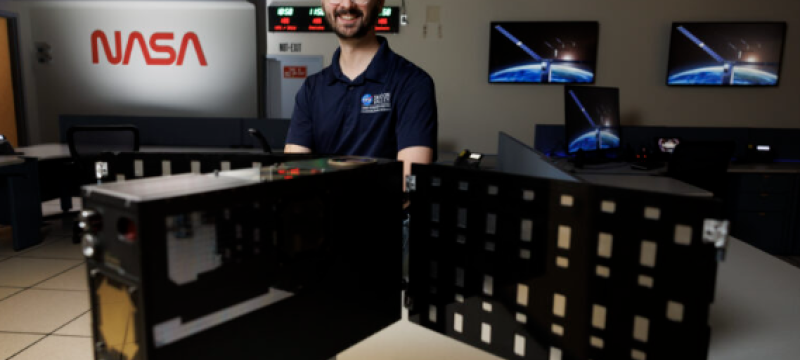 photo of man, with equipment, screens and signs