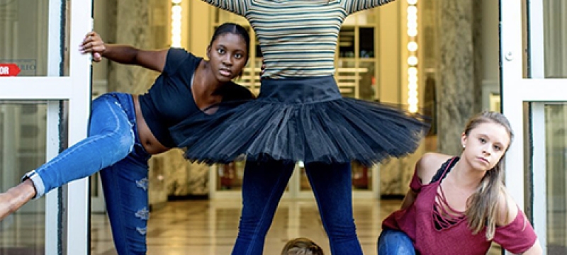 photo of four dancers posed at the library door