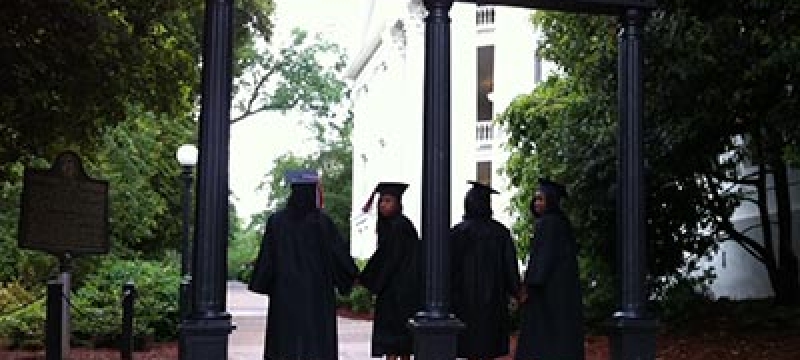 caps and gowns at the arch