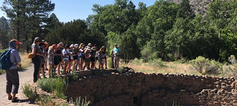 students standing near ancient burial site