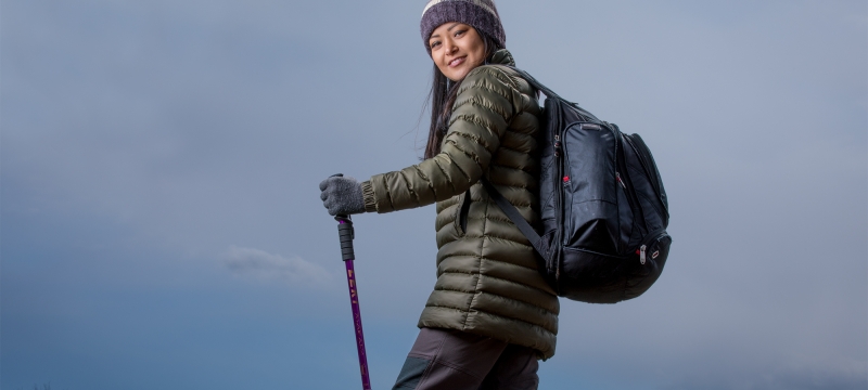 photo of woman on mountain hike, with walking stick