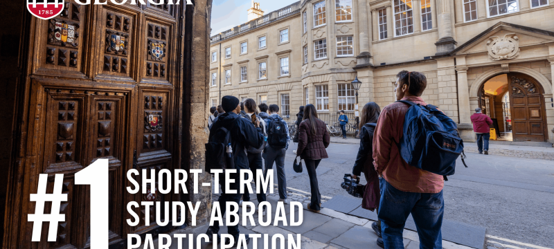 photo of city street  with people, white text