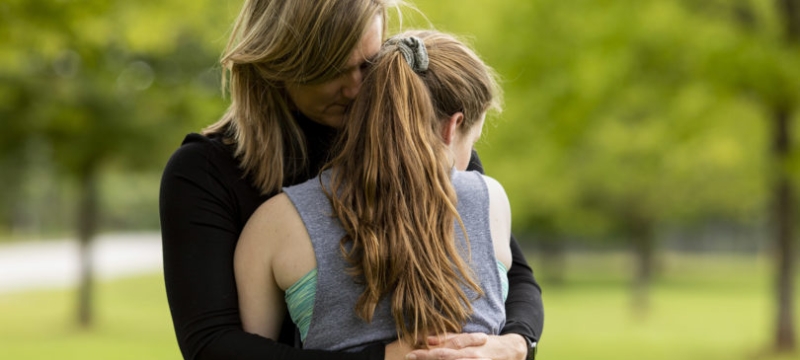 photo of woman and girl in embrace