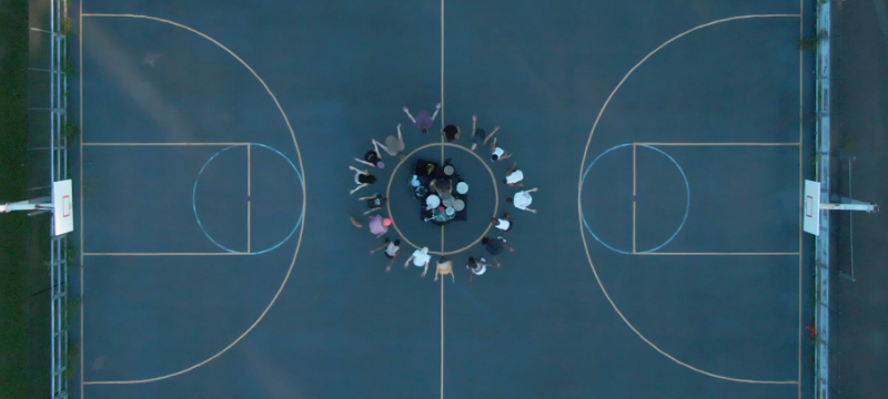 photo of basketball court with people at the center, from above