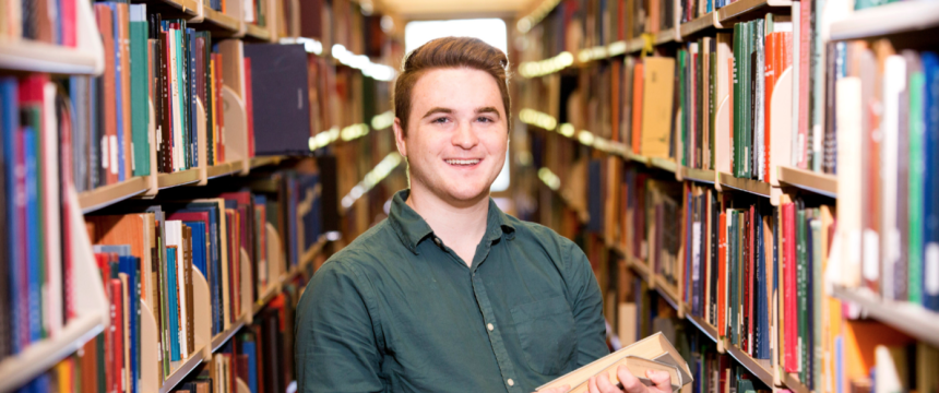 Environmental portrait of undergraduate Amazing Student Nicholas Twiner in the main library