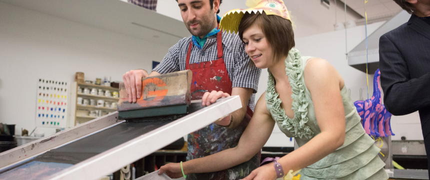 Lamar Dodd School of Art Open House|l-r: Michael Levine, a 3rd year MFA printmaking major from Glastonbury Connecticut|and Jessica Machacek, a 2nd year MFA printmaking major from Omaha, NE pull silk screen print onto