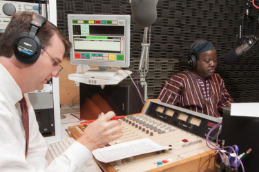WUGA operations manager Michael Cardin and "African Perspectives" radio show host Akinloye Ojo prepare for the show's 10 year anniversary broadcast.