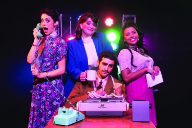 photo of four people, with telephone, typewriter, rolodex