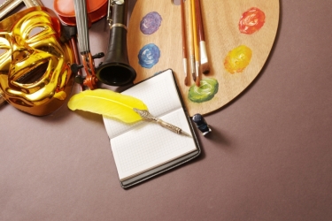 photo of palette, pen, mask, and instruments