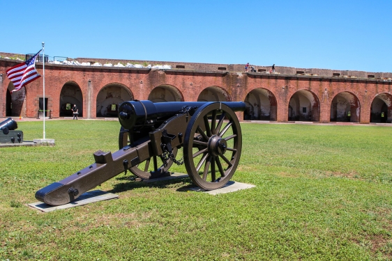 photo of interior of old fort, with cannon and grass