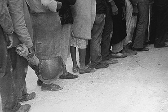 black and white photo of people standing in line