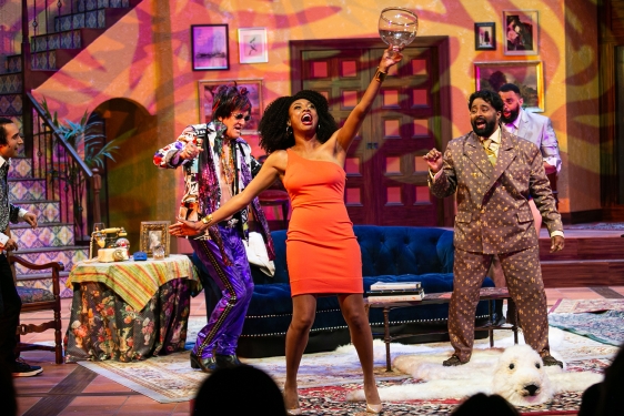 photo of stage drama with four people in colorful clothing and decorative set
