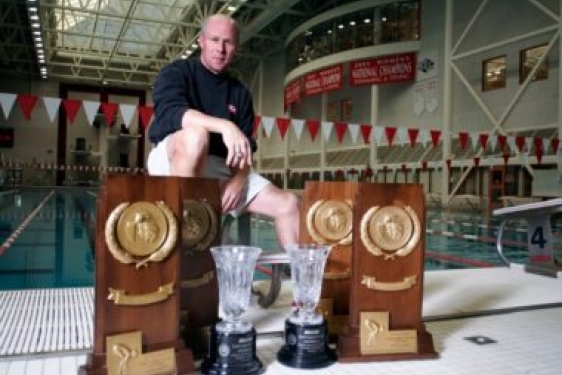 photo of many with trophies and plaques, with pool