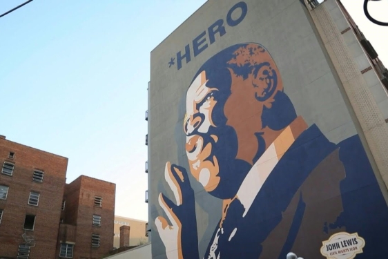 photo of a mural of man painted on side of a building
