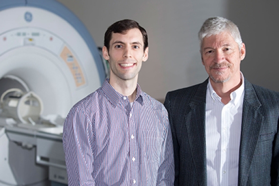 two men with fMRI machine 