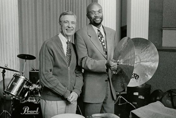black and white photo of two men, with drums and cymbals