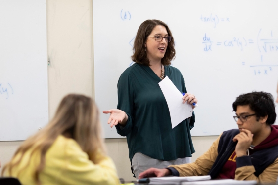 photo of woman speaking to students in classroom